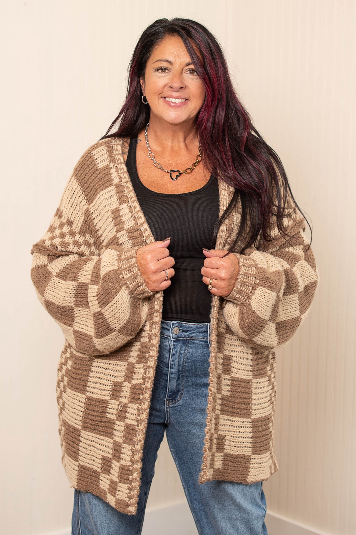 Taupe and cream checkered open front cardigan over black tank